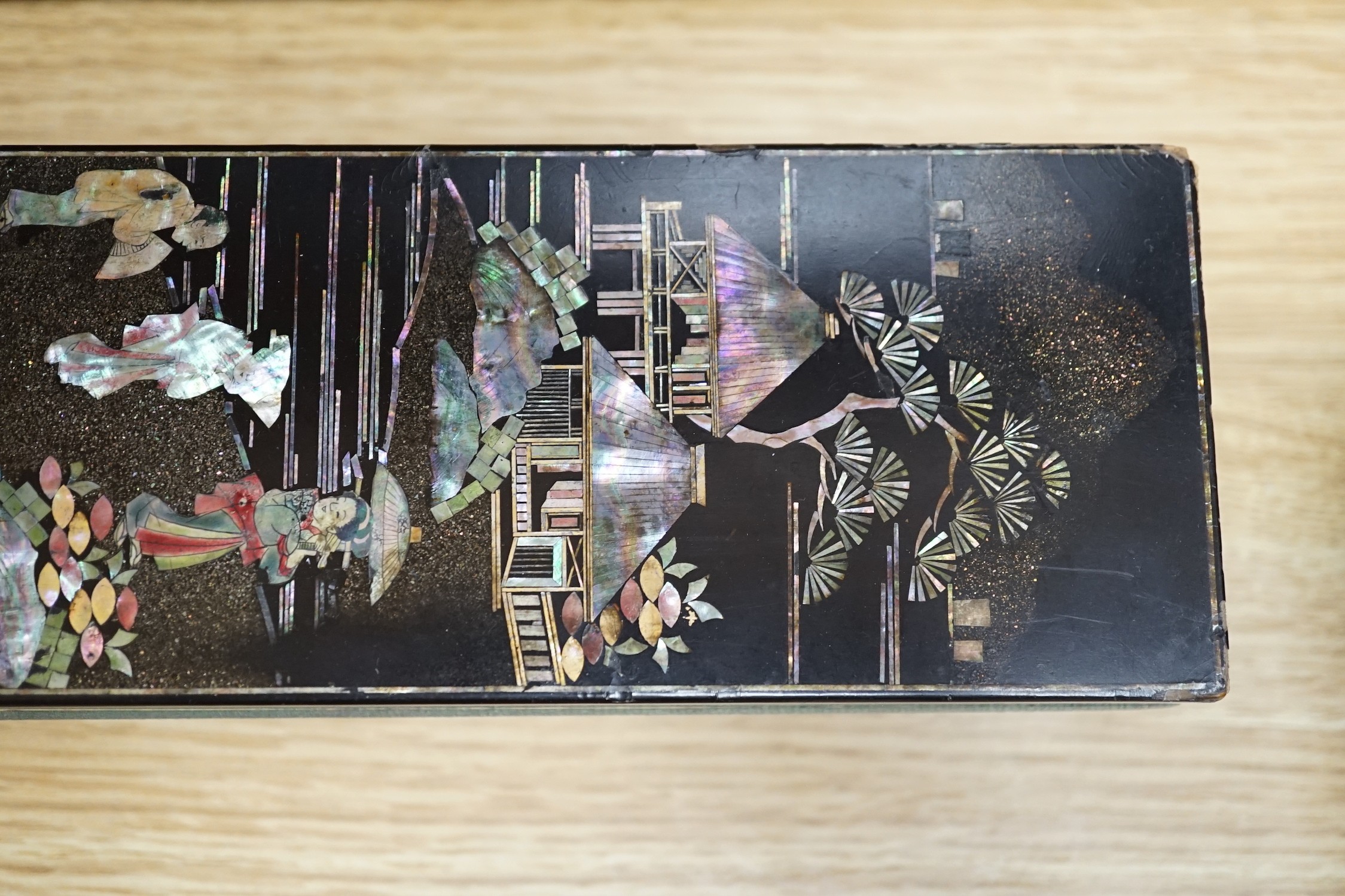 A late 19th century Chinese lacquer box, two smaller Japanese lacquer boxes, a doll, a collection of later paper fans etc, Chinese box 24cms high x 42cms wide
